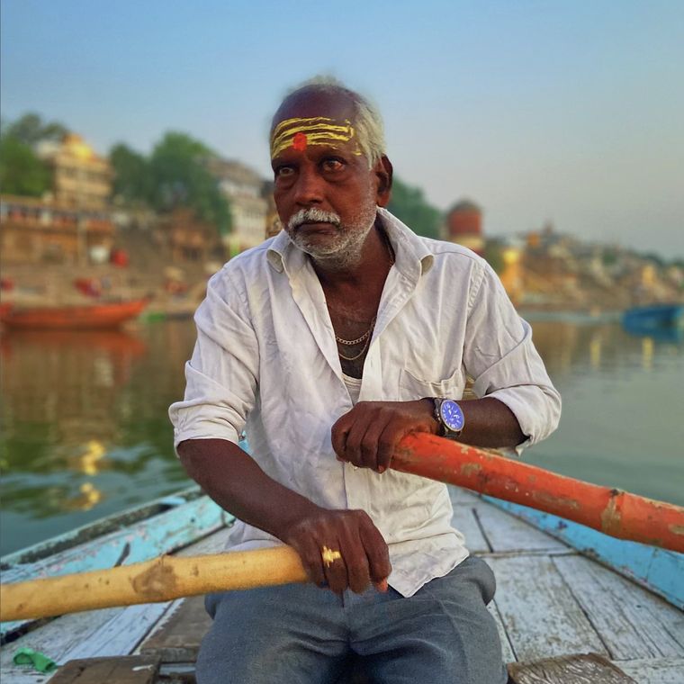 A boatman rowing on the Ganga at first light